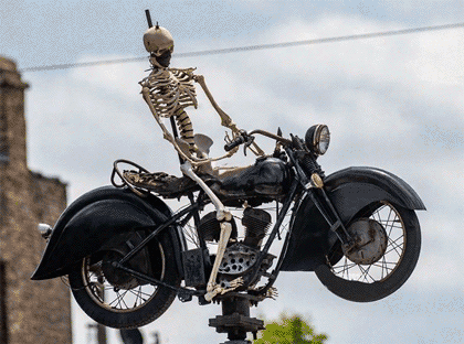 The rotating skeleton on a motorcycle above Ogden & Grand